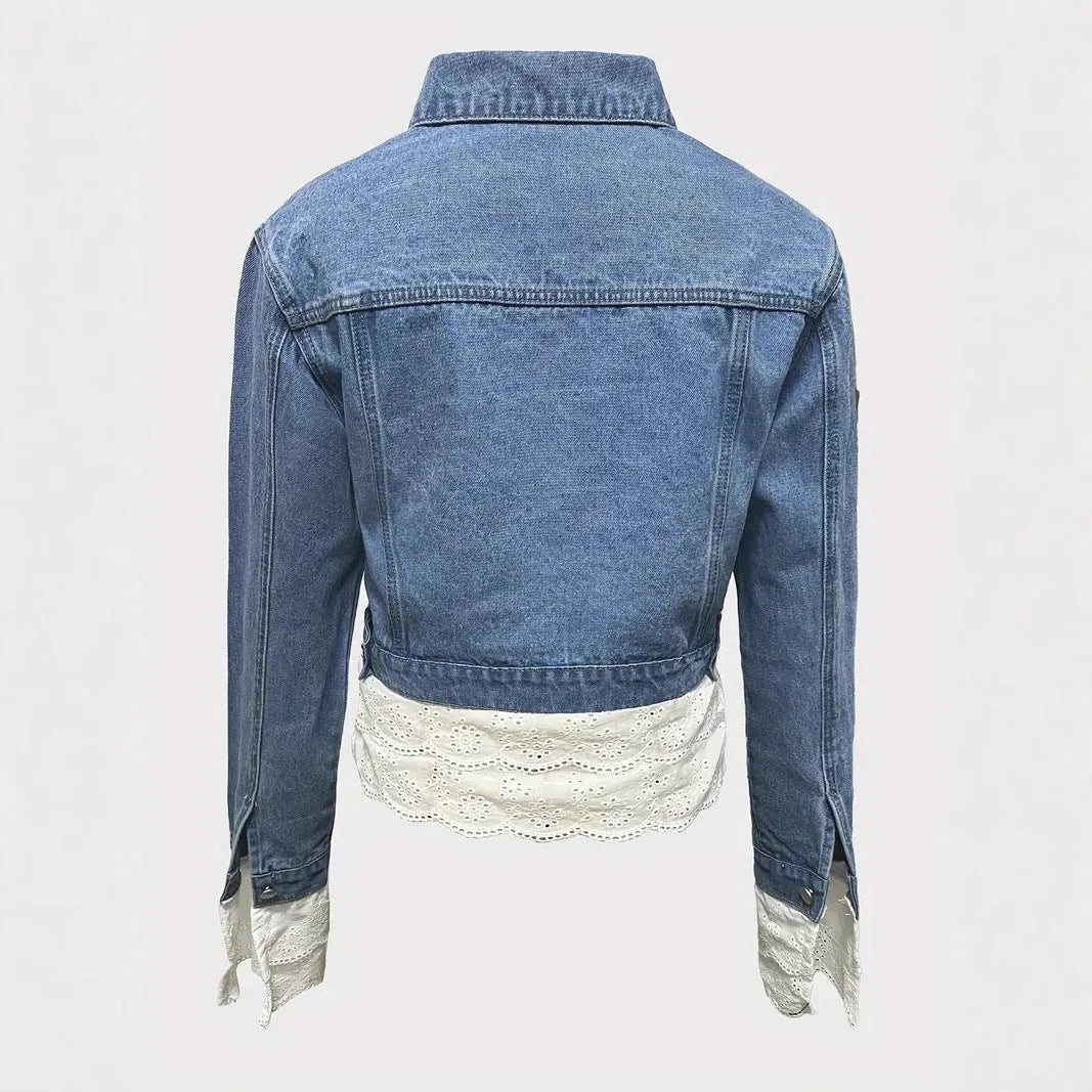 Blue denim jacket for women with lace stitching on the sleeves and front, shown on a hanger.