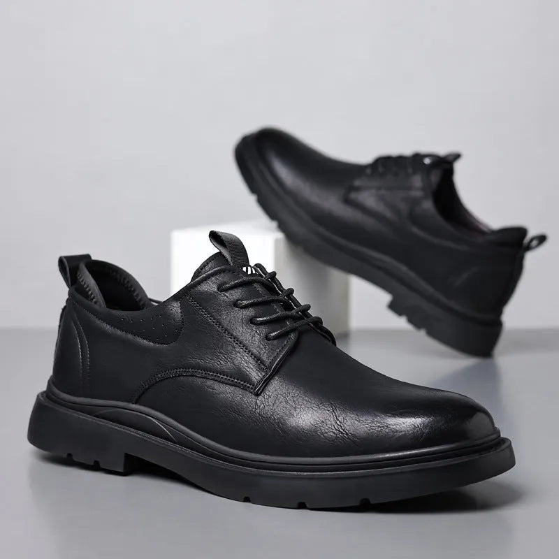 Men's black and brown leather casual sneakers with rubber sole and sewing line detail on the upper.