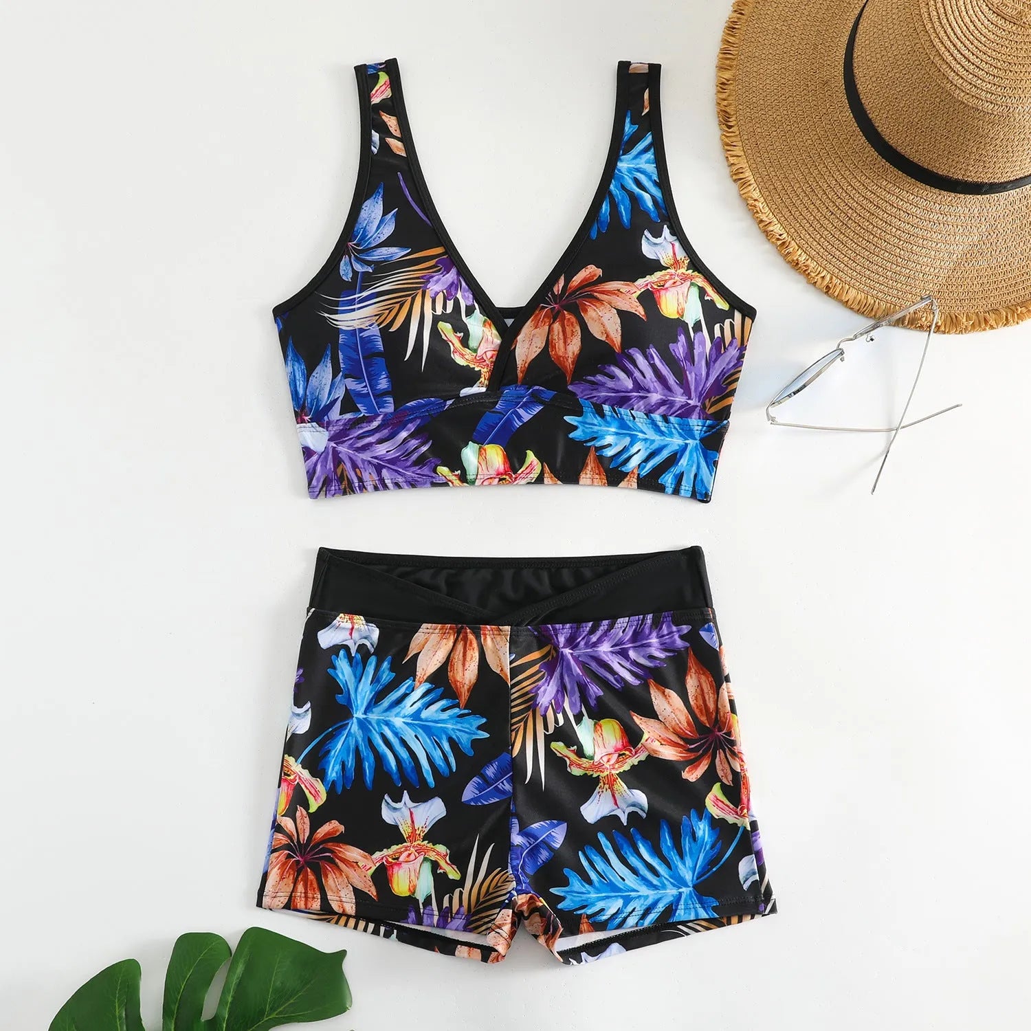 Women's two-piece printed swimsuit set with sleeveless top and boxer shorts in a multi-colour design.
