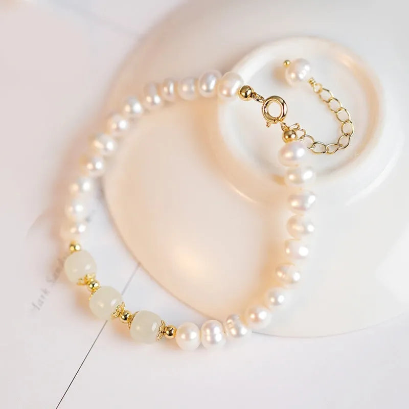 Korean style natural freshwater pearl bracelet with diamond-shaped beads in a Hetian jade electroplated finish.