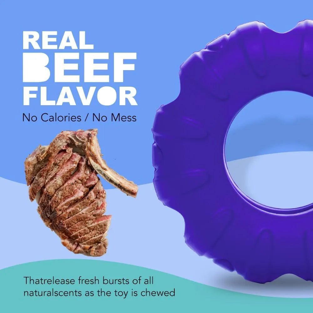 Blue rubber tyre-shaped dog chew toy with oval openings, shown next to dog treats.