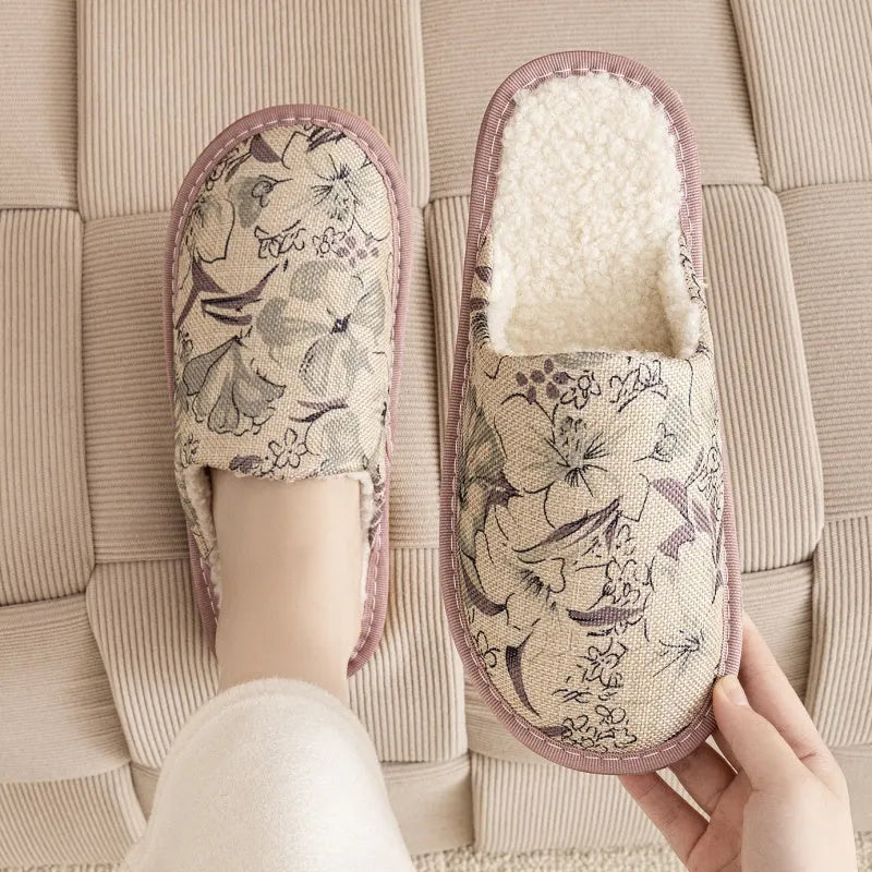 A pair of linen surface cotton lined slippers with a PVC sole, shown in a floral print colour option.