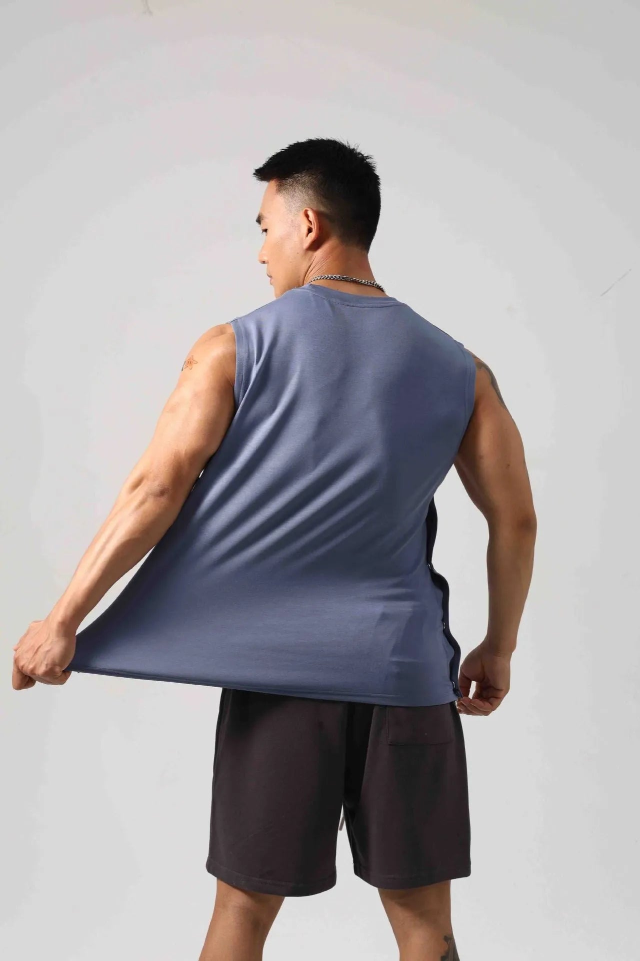 Korean style men's loose cotton fitness vest with hidden hook side openings in black, blue, grey, or white.