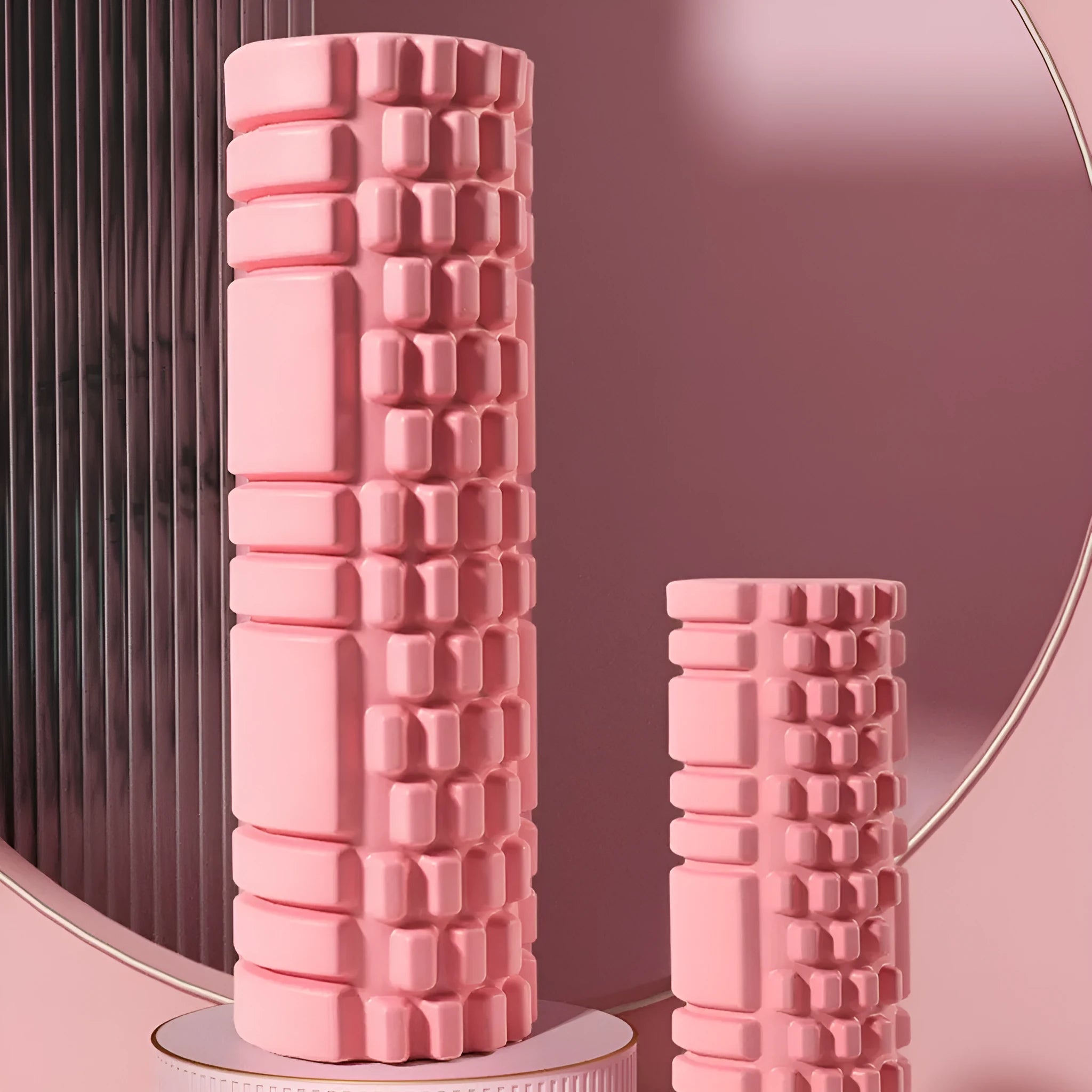 EVA foam roller in various colours including black, grey, pink, blue, and purple on fitness mat