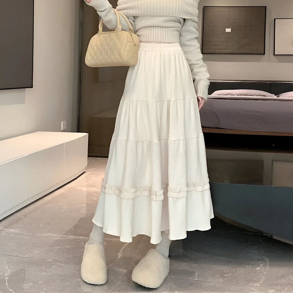 Korean style corduroy A-line midi skirt with an elastic waistband in a solid colour.