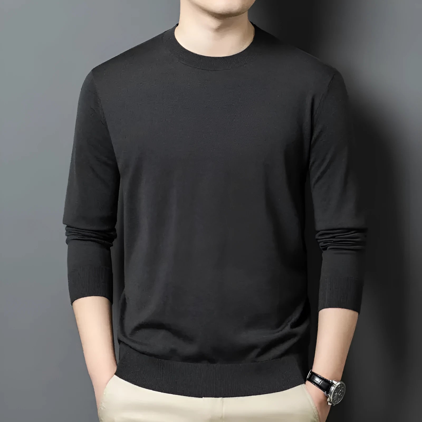 Man wearing a round neck long sleeve wool blend pullover sweater in a neutral colour.