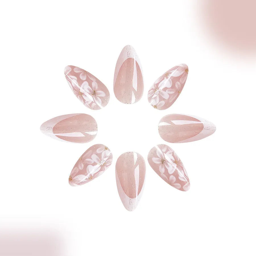 Short almond French manicure press-on nails with glitter flower designs in colour C625