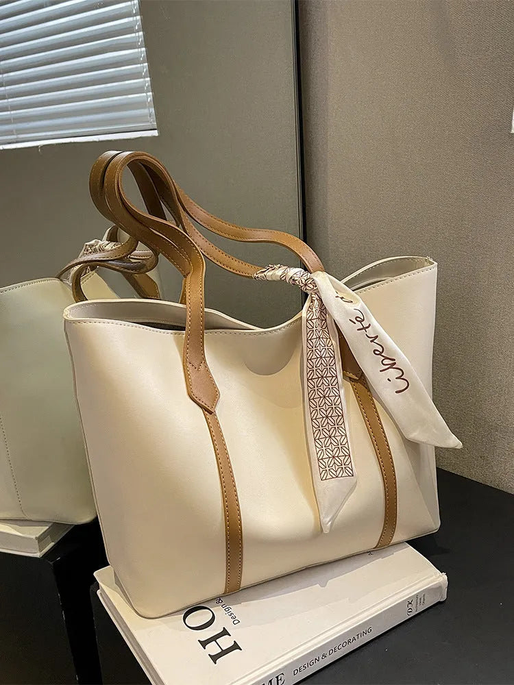 Large casual tote bag with bucket shape showing internal zippered pocket and sewing line detailing