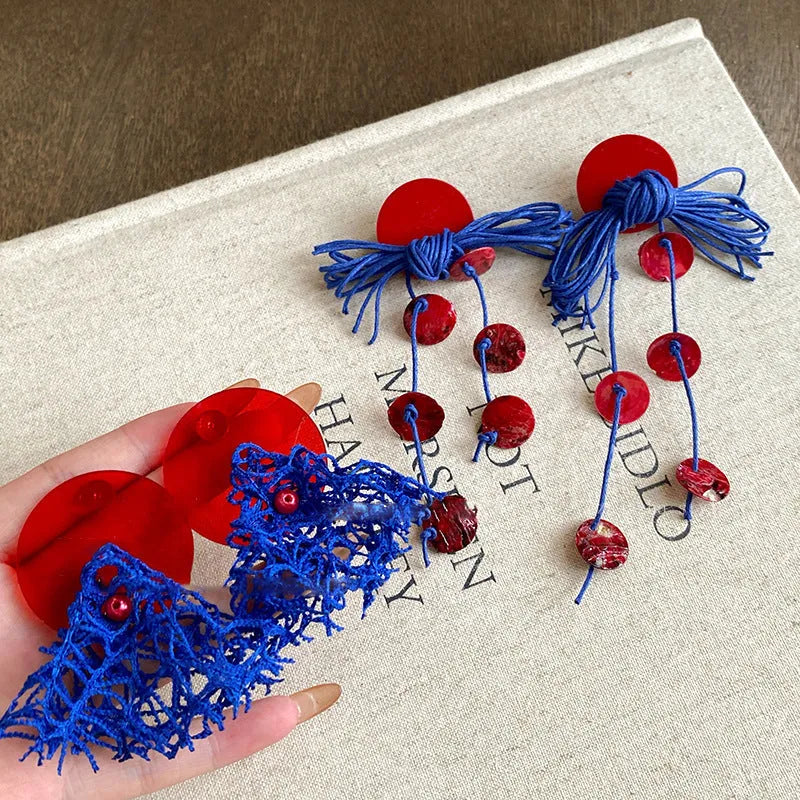 Blue geometric earrings with resin flower detailing and cloth material construction