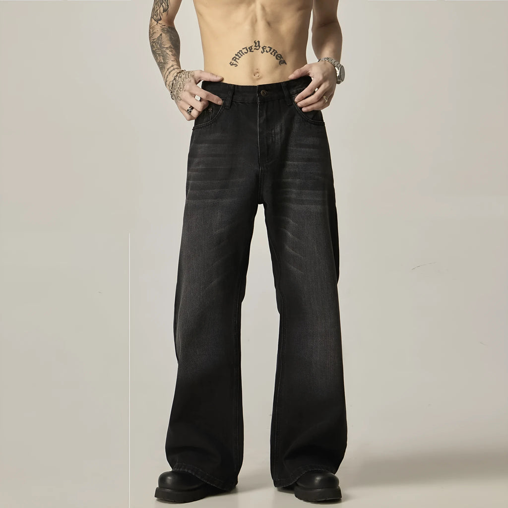 Black loose straight-leg retro jeans on a hanger, showing the front view with zipper fly.