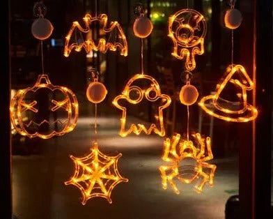 Seven Halloween-themed LED hanging lights with suction cups including spiders, pumpkins and ghosts