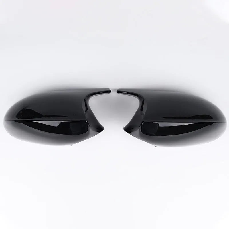 Pair of black ABS plastic rearview mirror shells for BMW 3 Series E90, shown alongside original equipment part numbers.