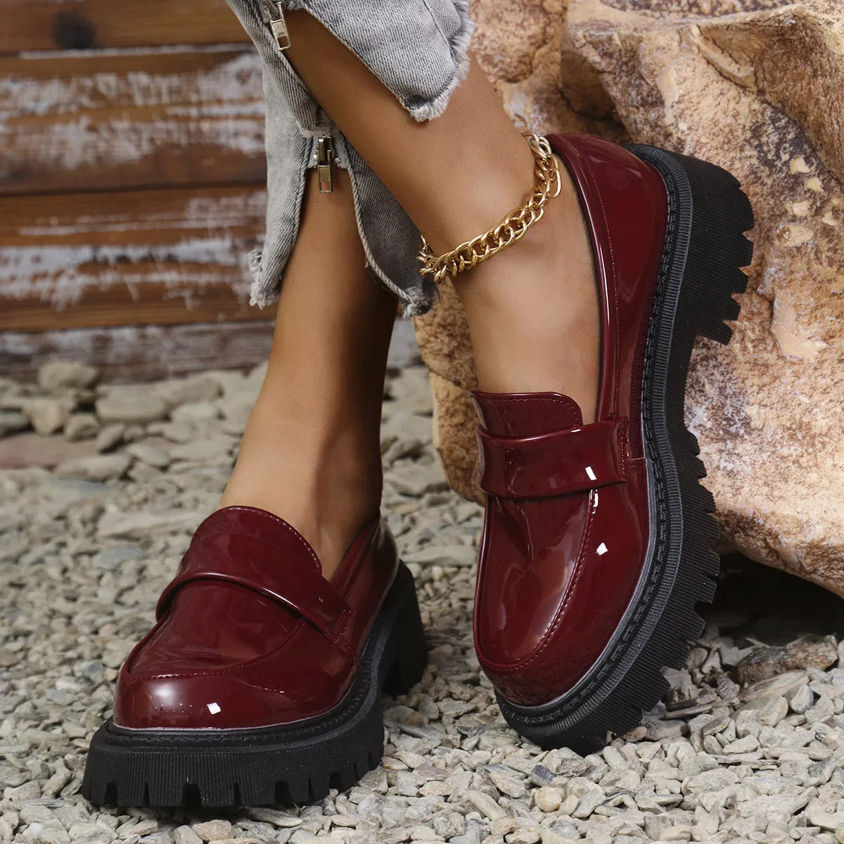 Plus size women's slip-on loafers in black with a chunky platform heel and rubber sole.
