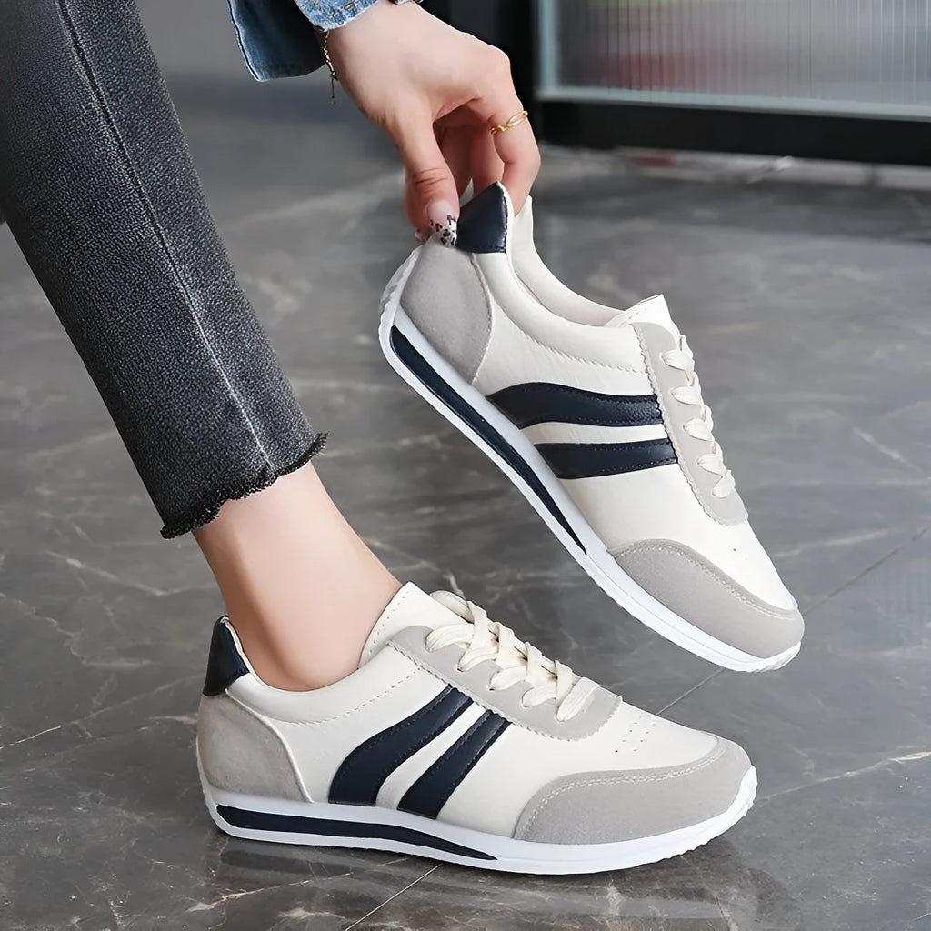 Red and blue low-top lace-up running sneakers on a white background.