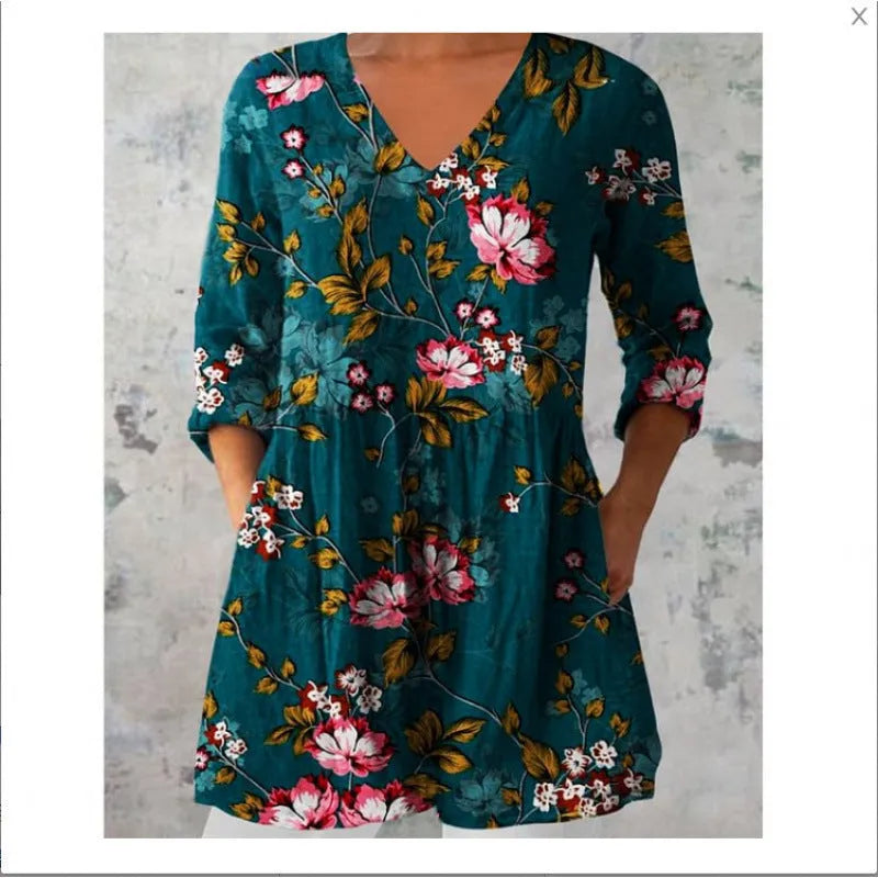 A woman modelling a printed, loose-fitting dress with a wide waist and three-quarter length sleeves.