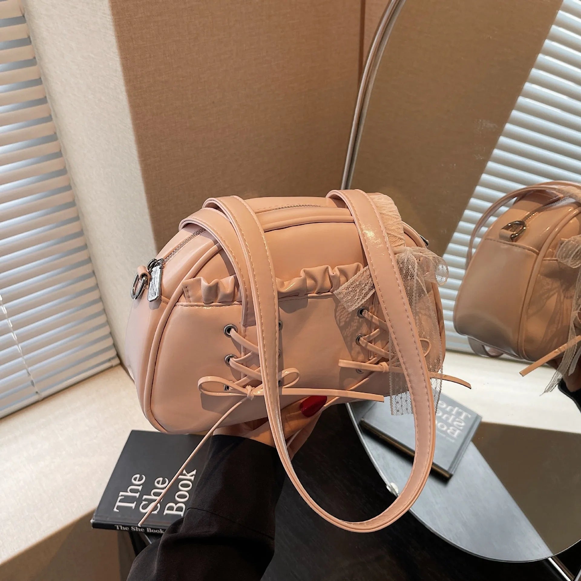 Milky white women's PU leather shoulder bag with a removable bandage bow and visible sewing thread detailing
