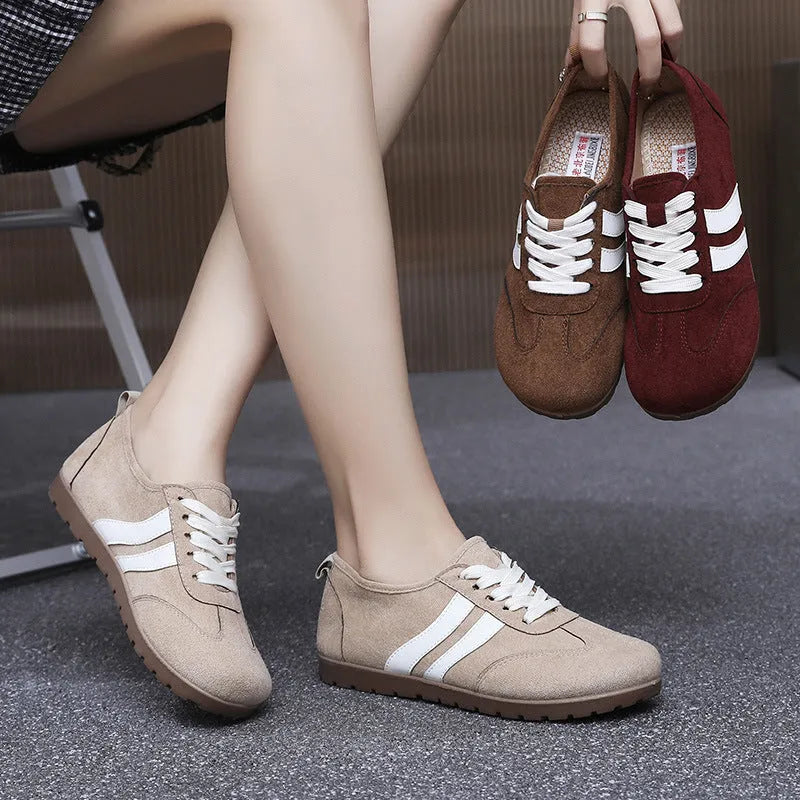 Women's vintage canvas sneakers in dark red and khaki with a round toe and flat rubber sole.