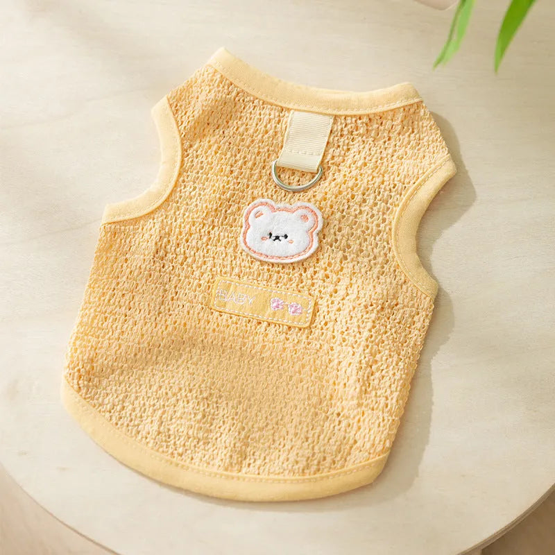 Green knitted cat clothes with a hollowed-out design and a cartoon bear patch.