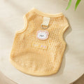 Green knitted cat clothes with a hollowed-out design and a cartoon bear patch.