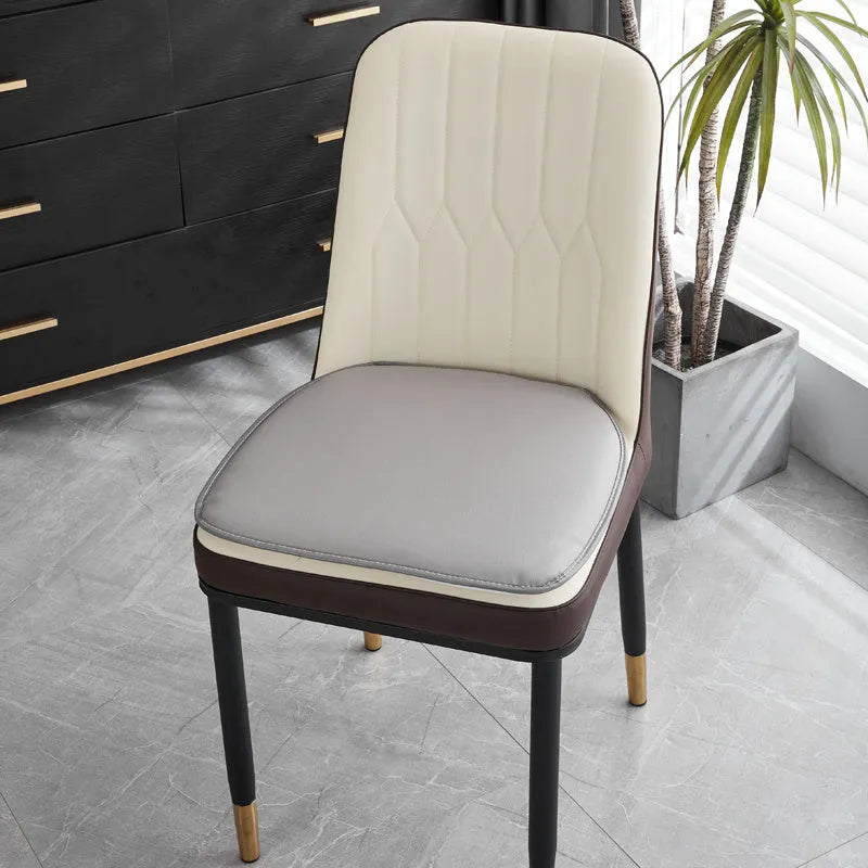 Brown leather horseshoe-shaped seat cushion with non-slip backing on a wooden chair.