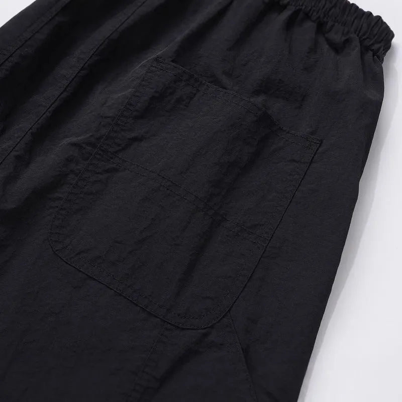 Black paratrooper trousers with elastic drawstring waist and three-dimensional cutting in baggy style