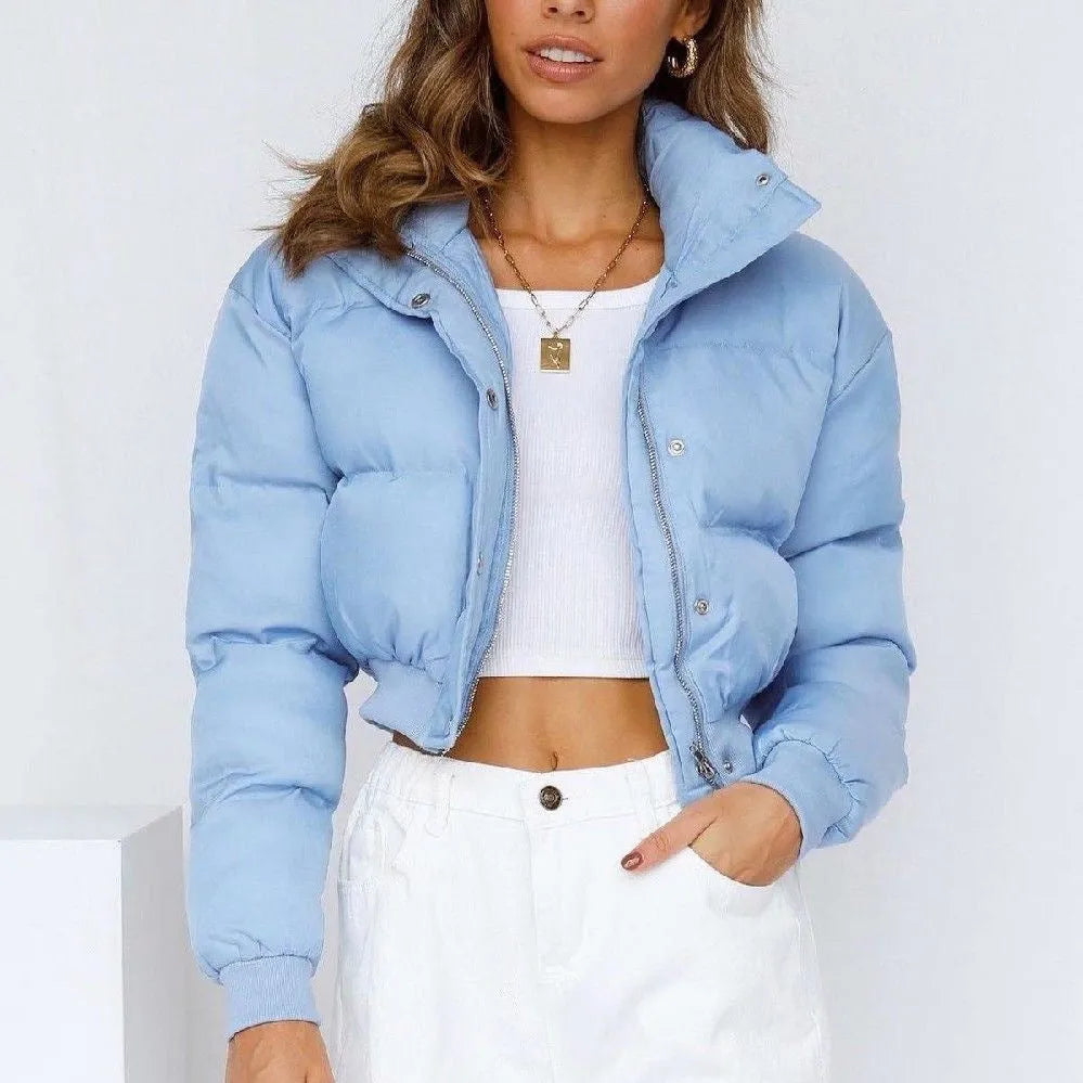 Blue loose fit polyester jacket for women with long sleeves on a hanger.