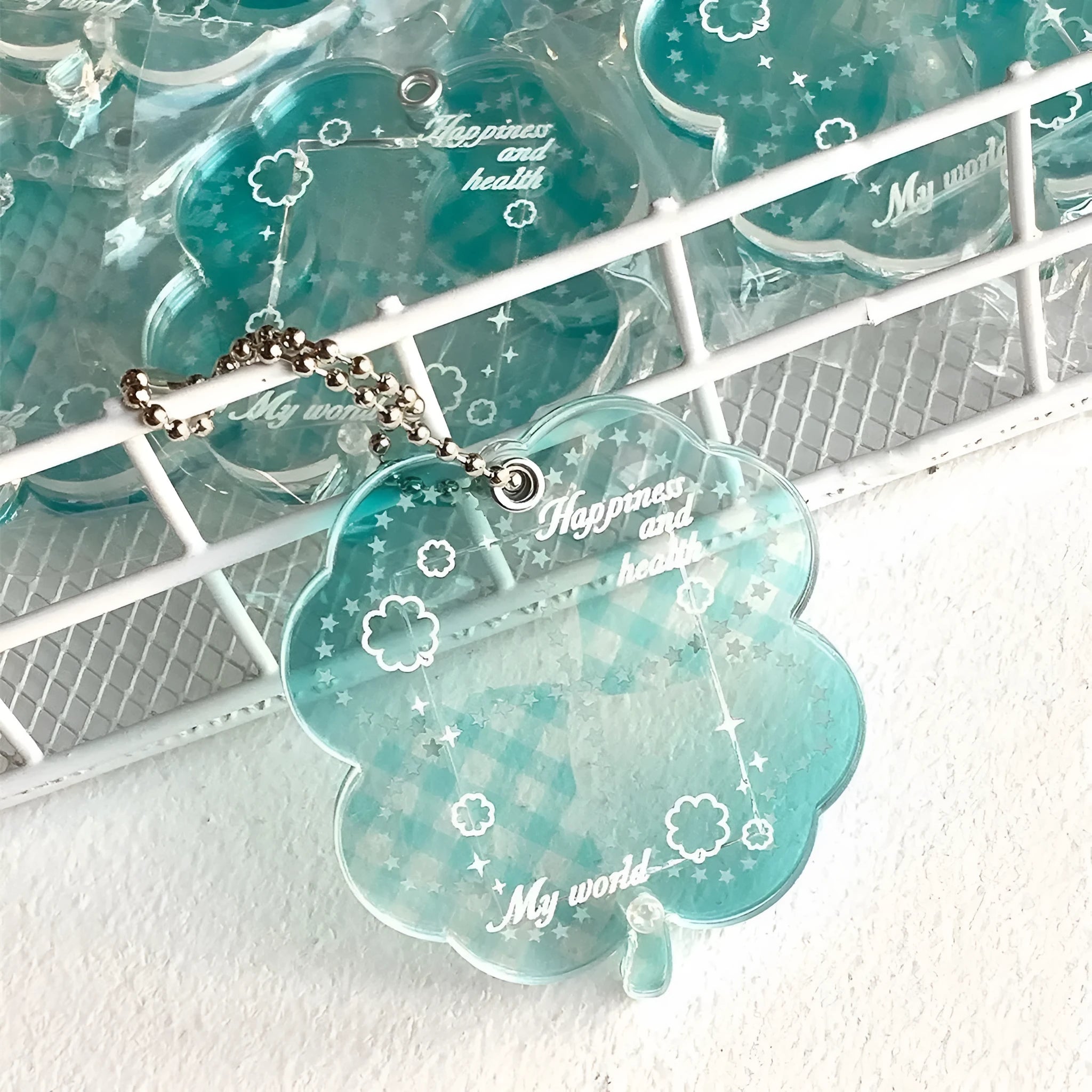Acrylic four-leaf clover shape keychain pendant for phones in blue, green, or mint.