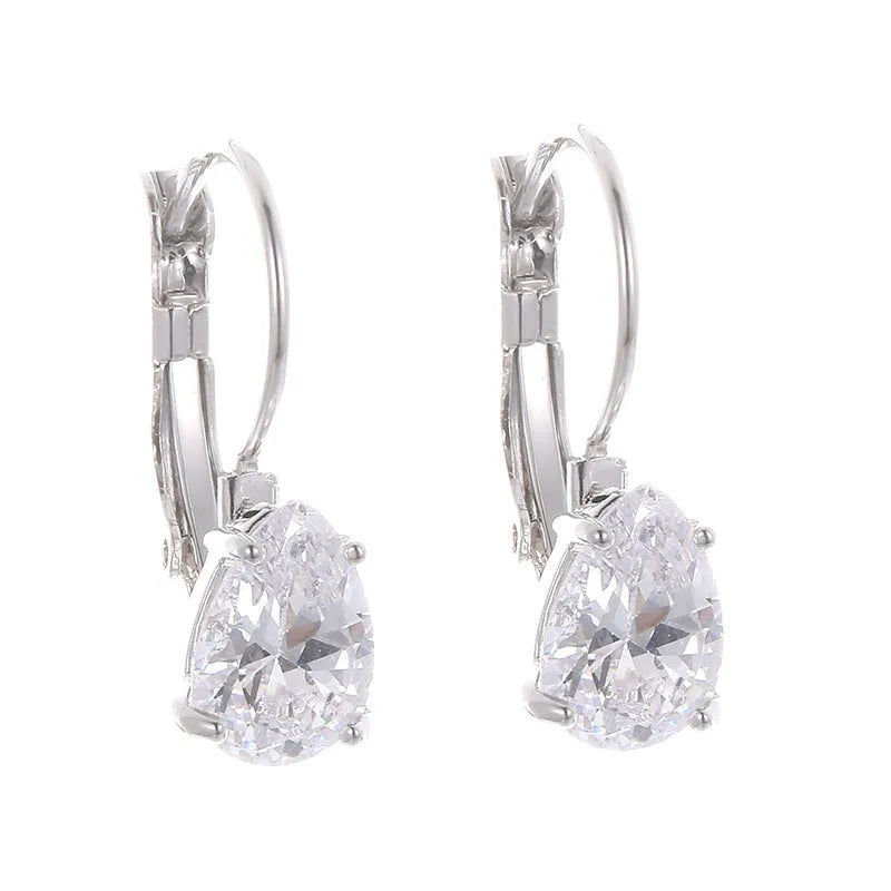 Drop-shaped metal earrings in gold or platinum finish with inlaid gem detailing