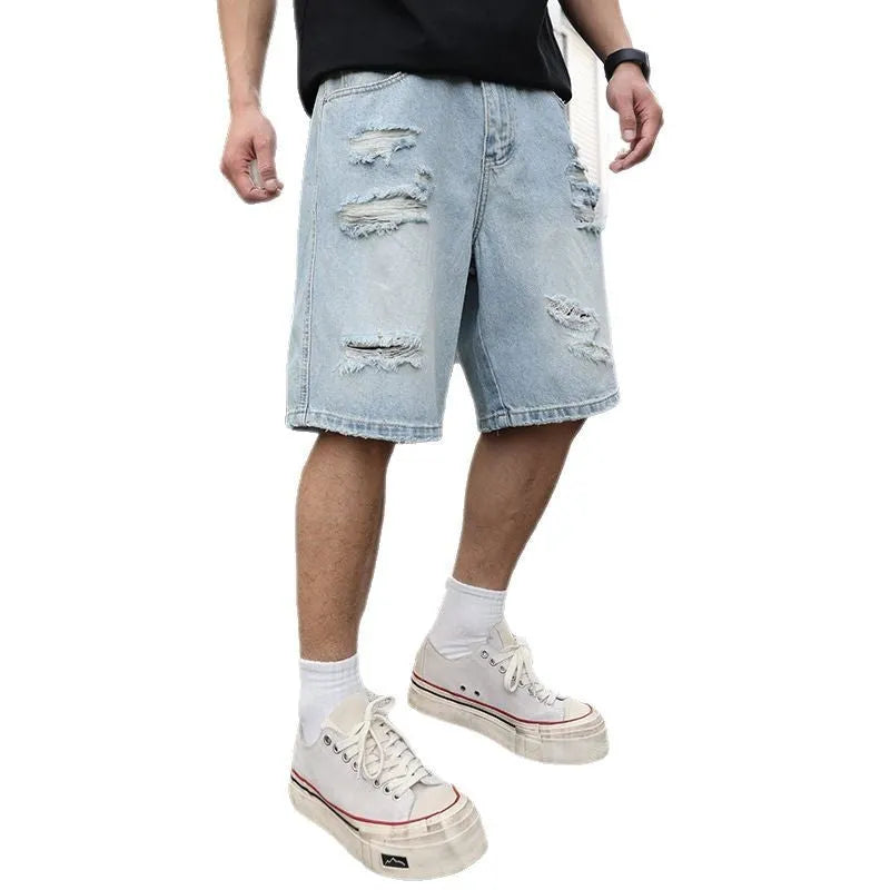 Light blue distressed denim shorts with ripped detailing and straight cut hip hop style
