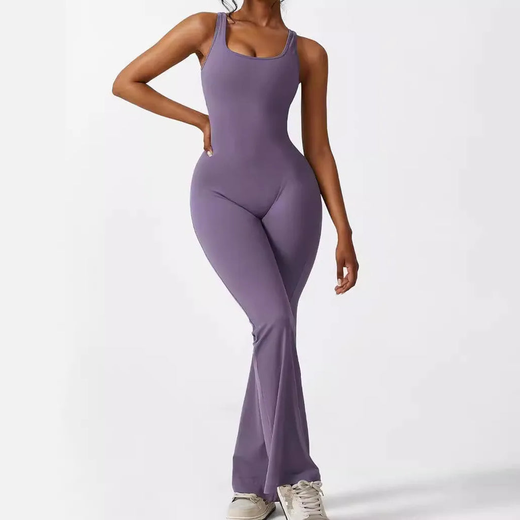 Woman wearing a sleeveless flare-leg jumpsuit for yoga in Army Green, showcasing the fashionable waist and full length.