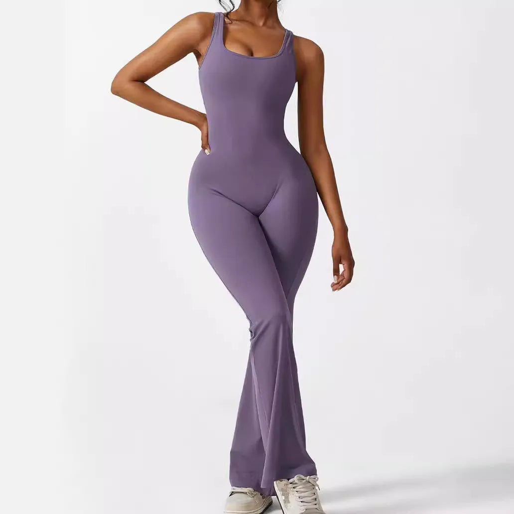 Woman wearing a sleeveless flare-leg jumpsuit for yoga in Army Green, showcasing the fashionable waist and full length.