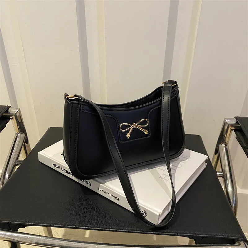 Western style baguette shoulder bag with bow detail showing horizontal square shape