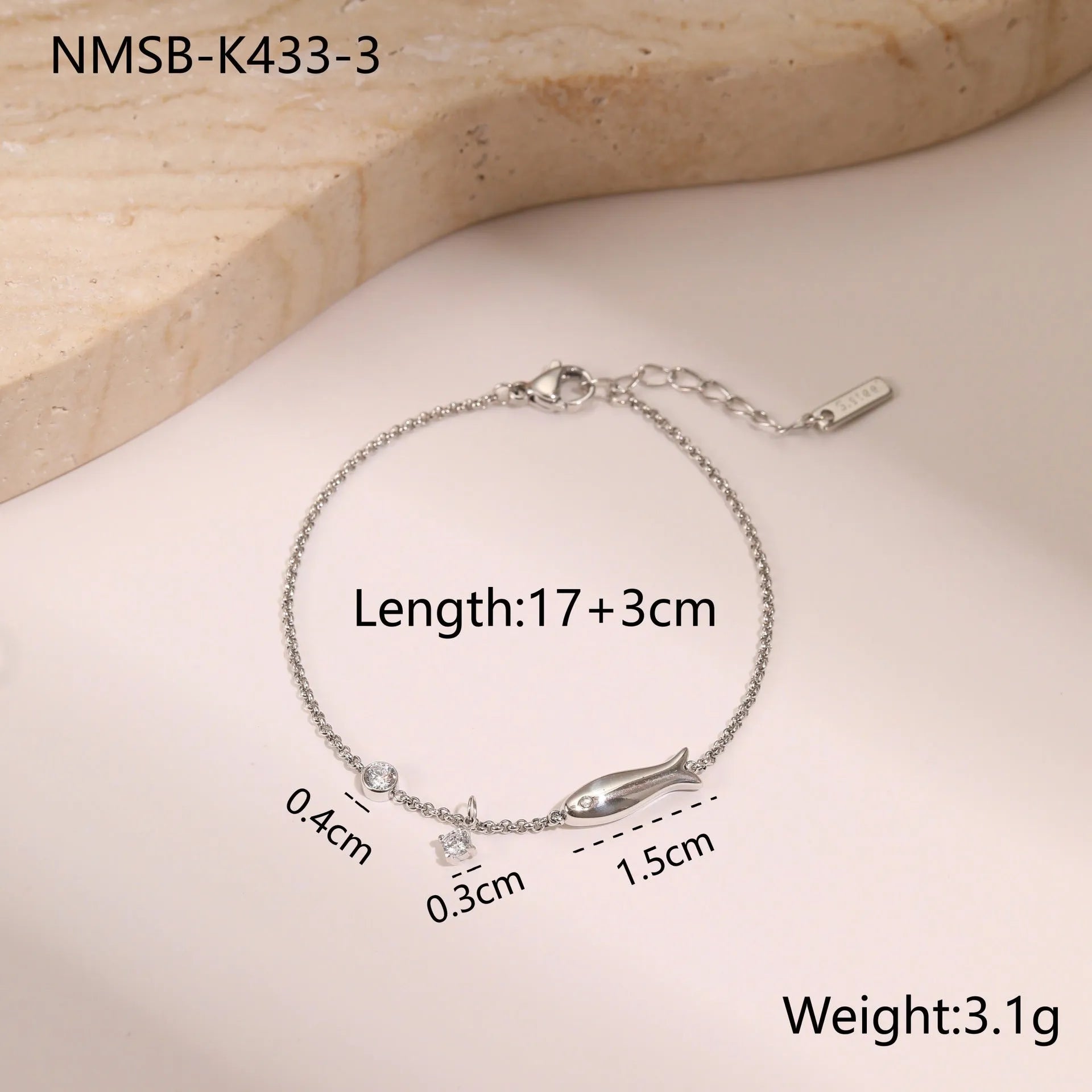 Women's stainless steel bracelet with 18K gold plating and a geometric zircon star pendant on wrist.