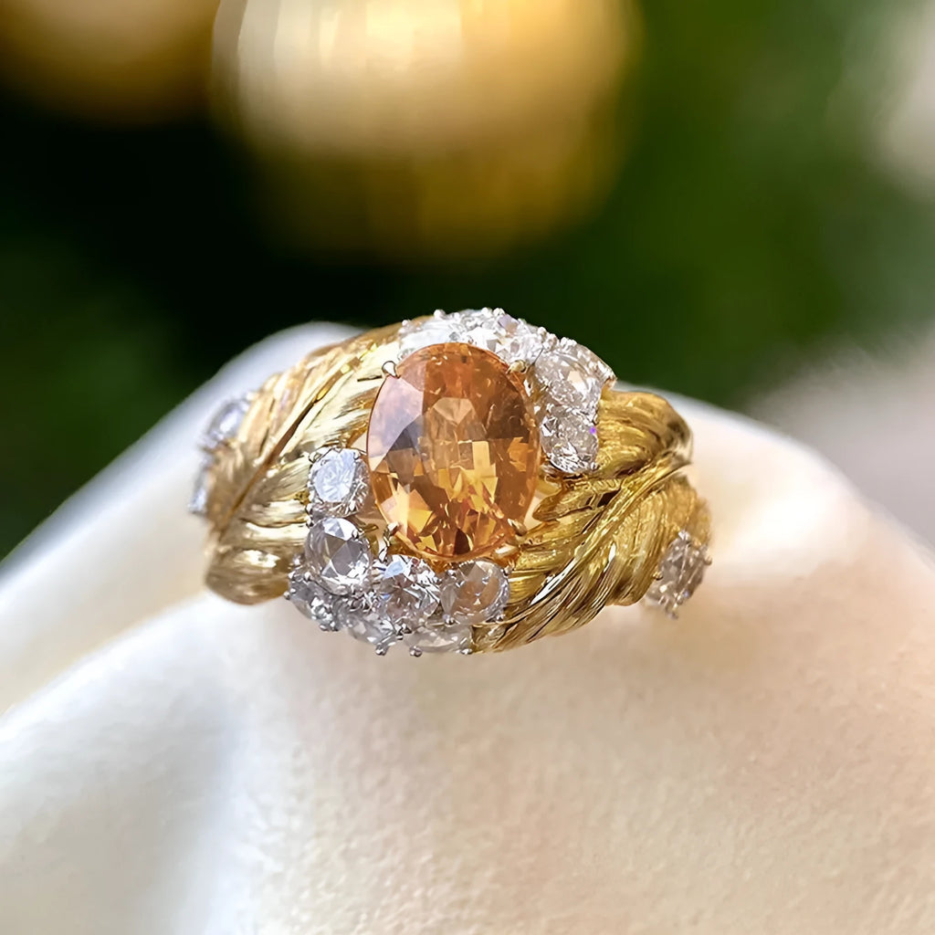 Gold-coloured embossed feather ring with geometric shape and zircon inlay, shown in women's fashion jewellery style