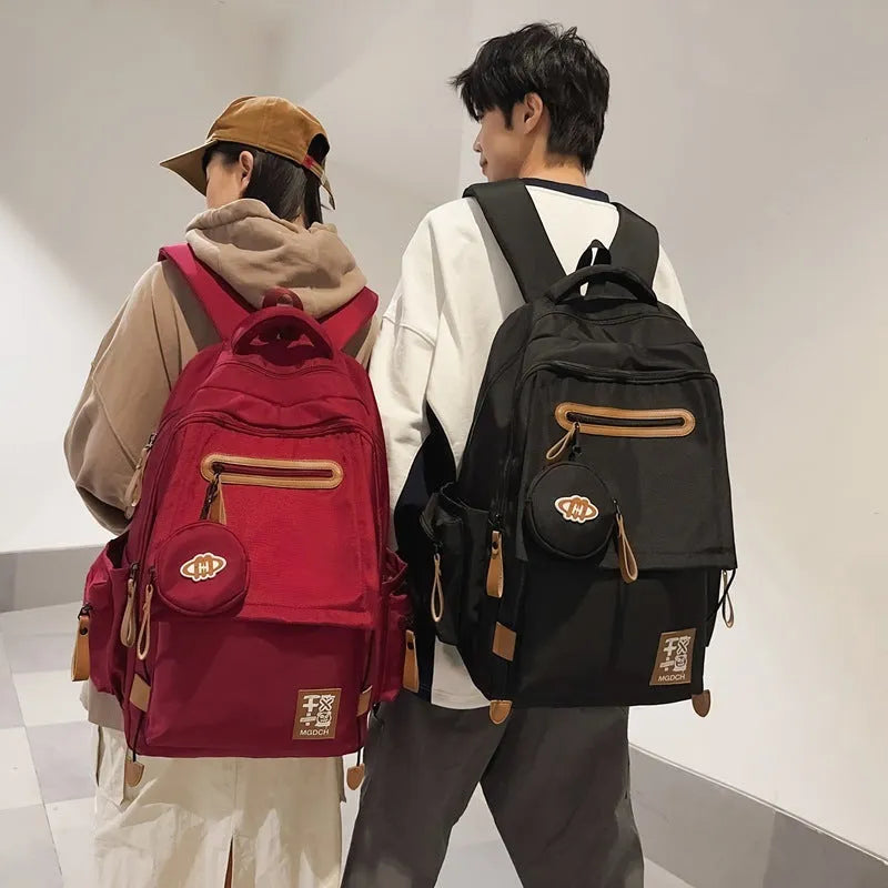 Large nylon backpack for middle school students with curved shoulder straps in solid colour options