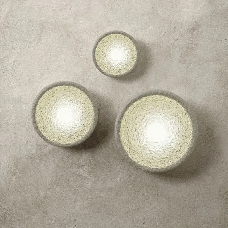 Japanese-style simple silent wall lamp with resin shade in three diameter sizes on white wall