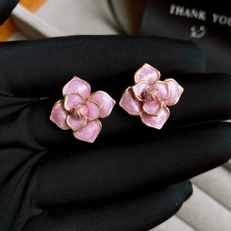 Gold plated purple flower stud earrings with an oil-spot glaze effect on copper