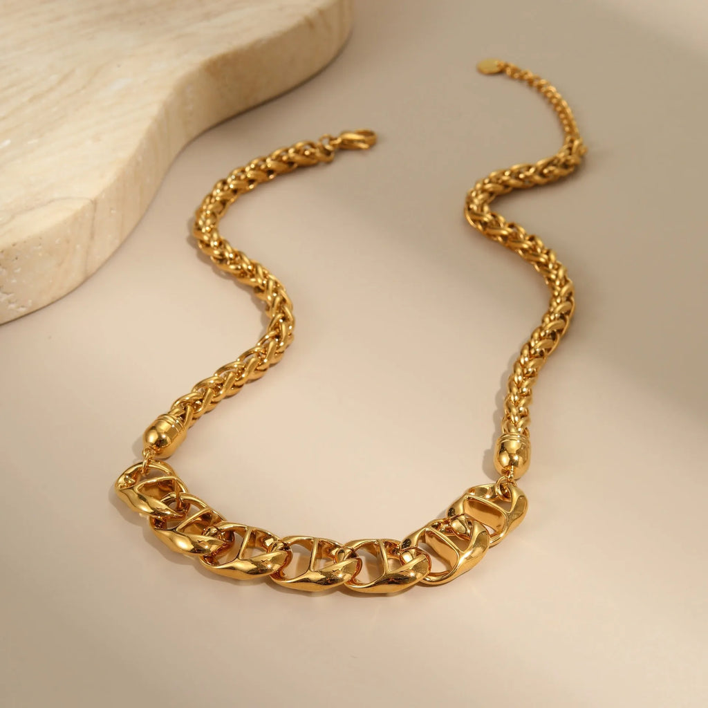Gold plated stainless steel geometric chain necklace for women on a white background.