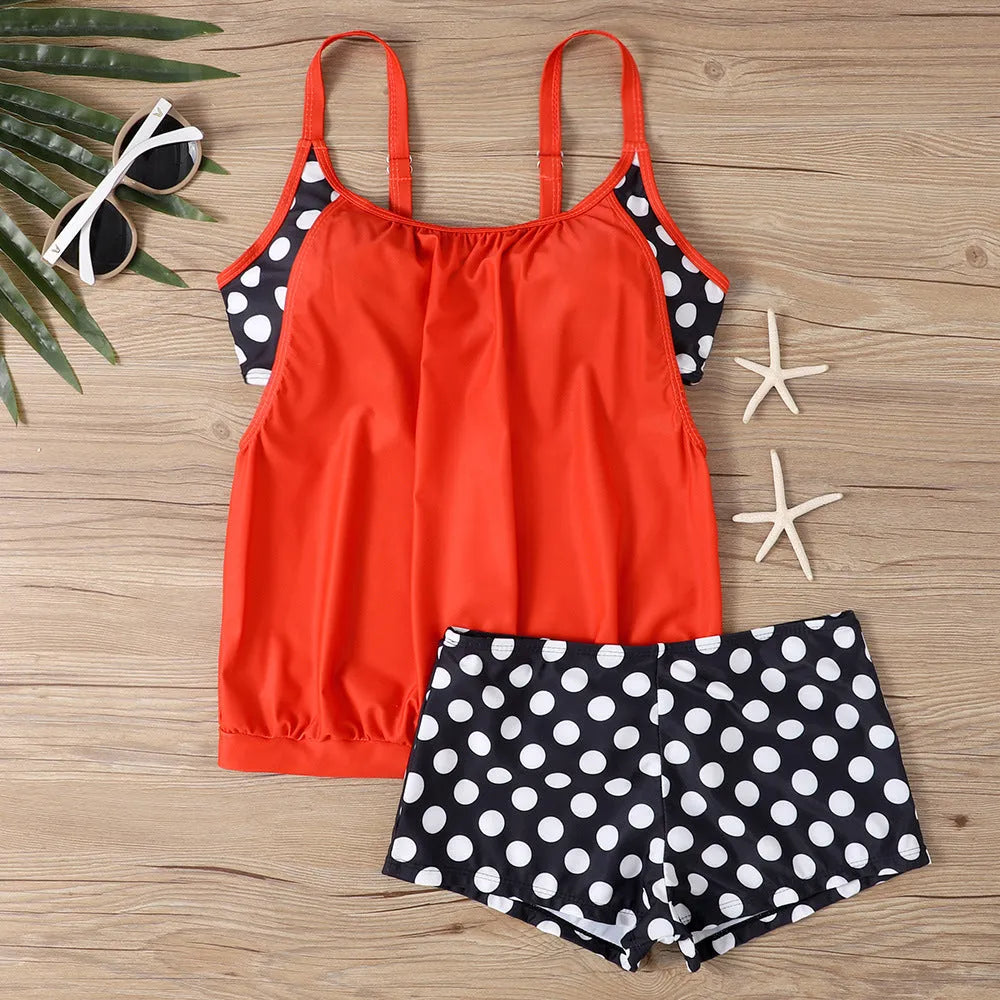 Women's black polka dot high-waist swimsuit with conservative briefs style on a mannequin.
