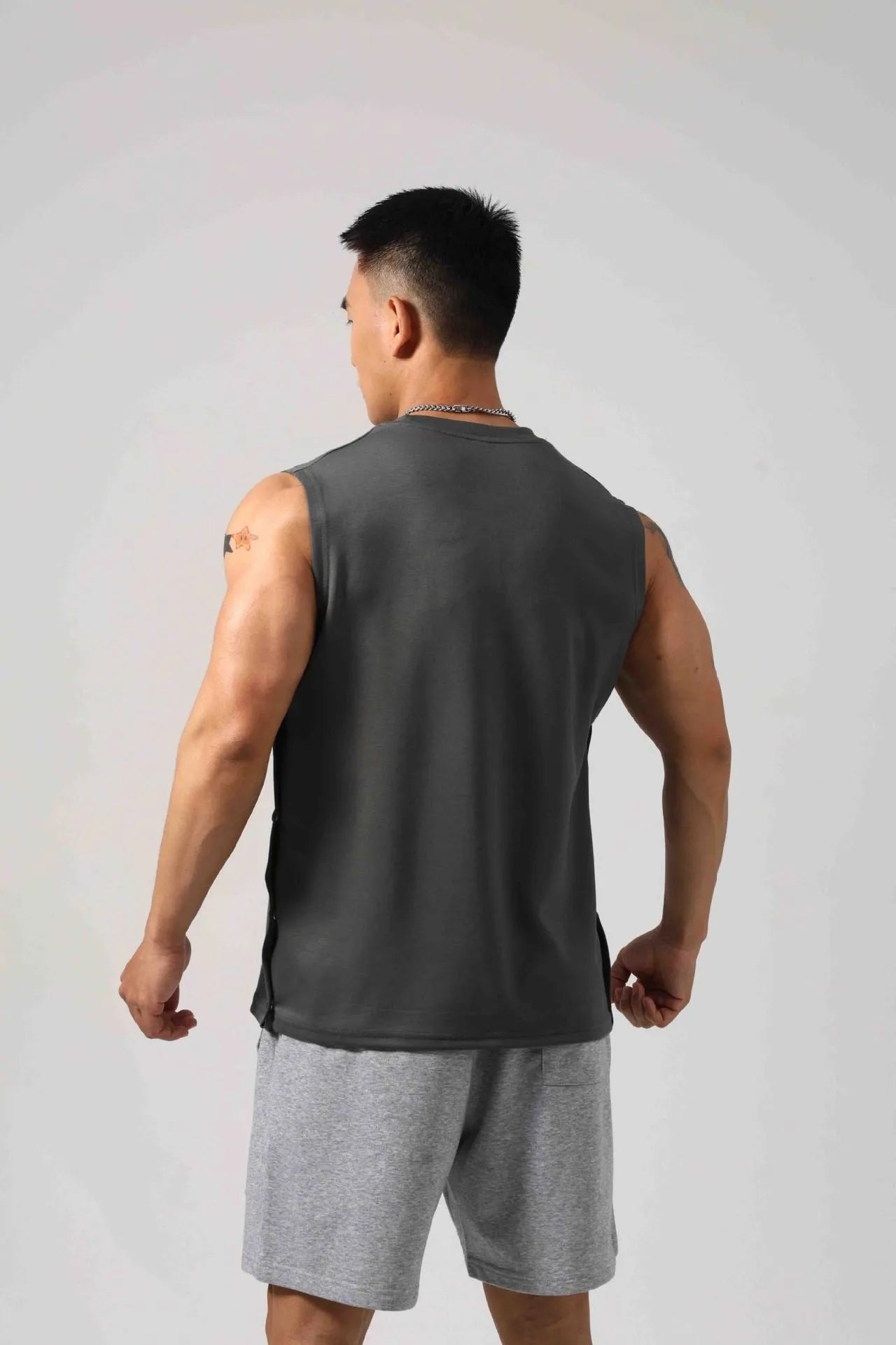 Korean style men's loose cotton fitness vest with hidden hook side openings in black, blue, grey, or white.