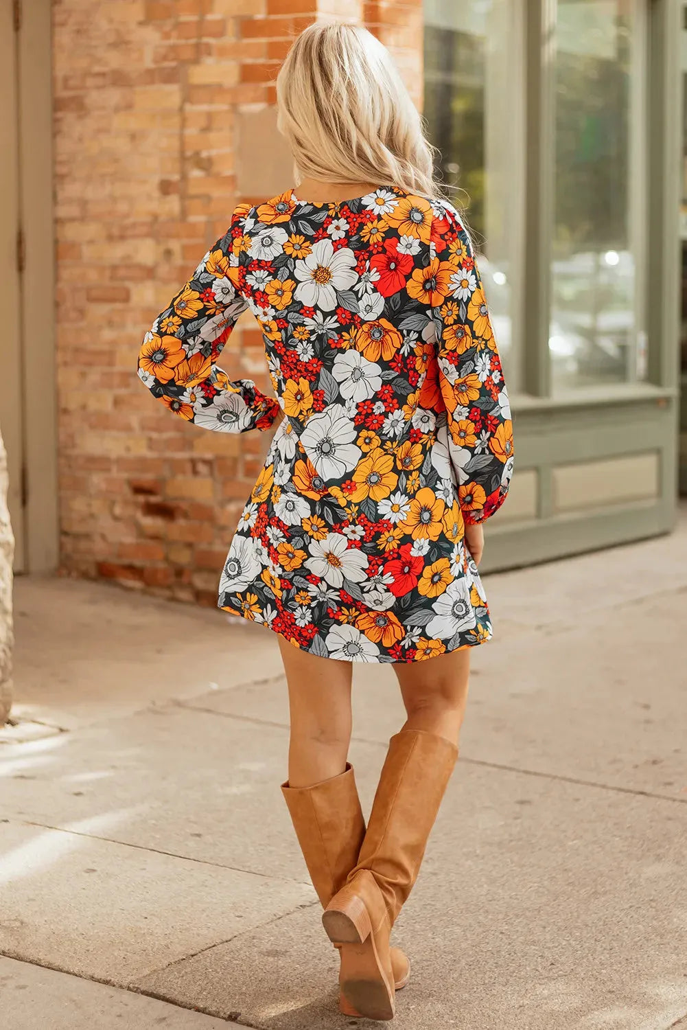 Orange floral print women's mini dress with lace-trimmed V-neck and long sleeves.