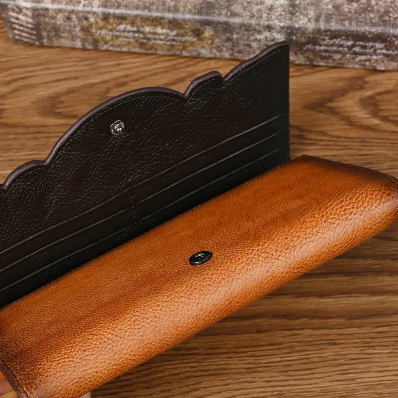 Retro brown embossed floral pattern tri-fold women's wallet made of genuine cowhide leather.