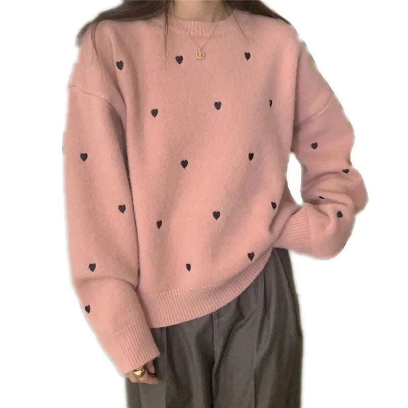 Women's loose grey acrylic pullover sweater with embroidery on the front, long sleeves, and a crew neck.