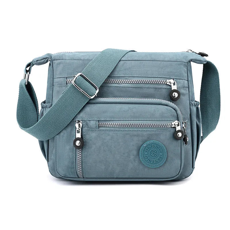 Soft nylon messenger shoulder bag in a choice of five colours including black and blue.