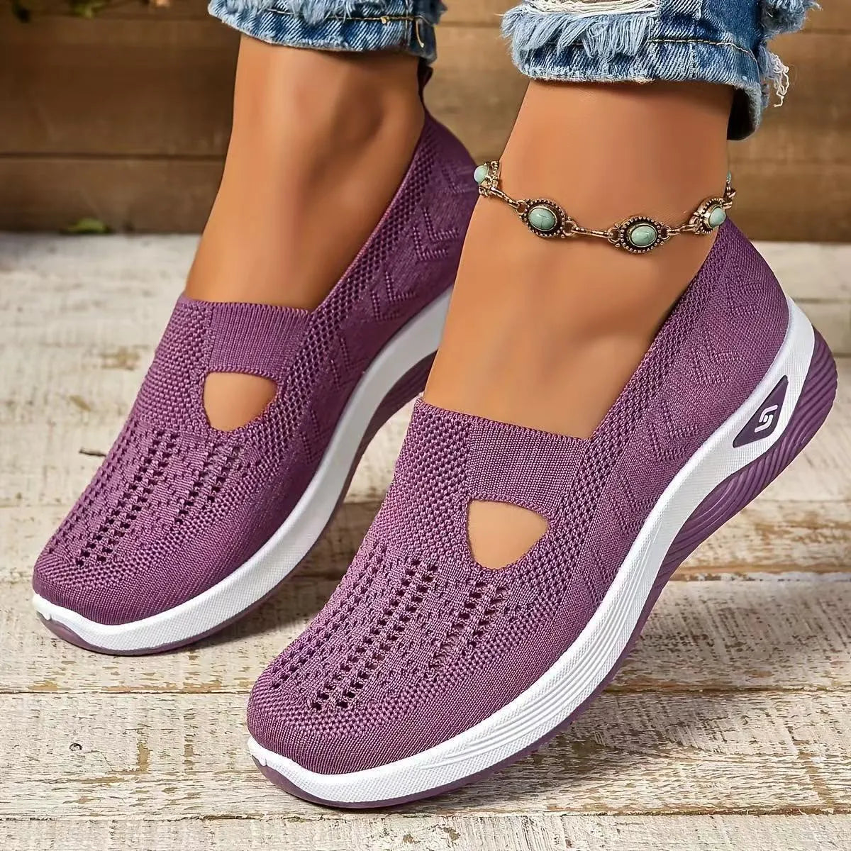 Elderly woman's black mesh T-strap shoe with soft PVC sole and round toe