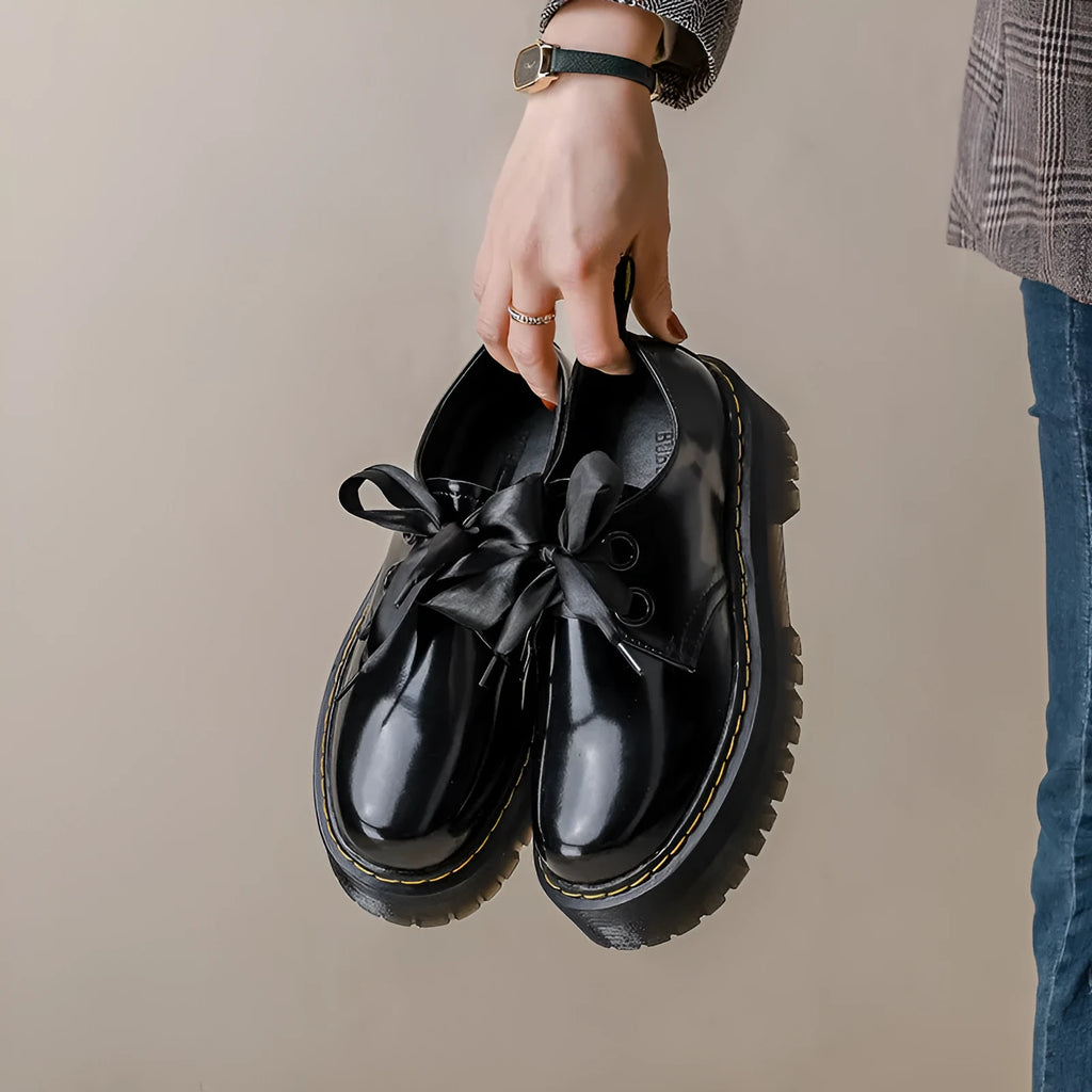 Women's thick soled leather shoes with ribbon and cross strap details in white or black