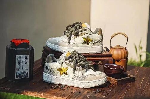 Green low-top casual sneakers with star pattern design on multi-material upper and rubber sole