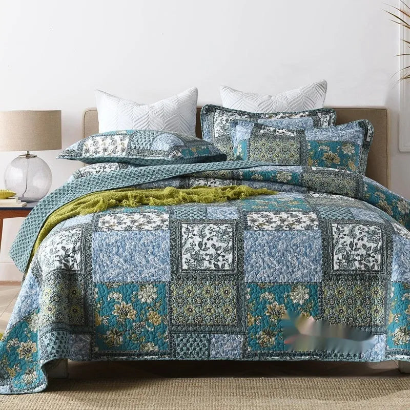 Quilted pure cotton bed cover set with printed pattern on a bed, includes two matching pillowcases.