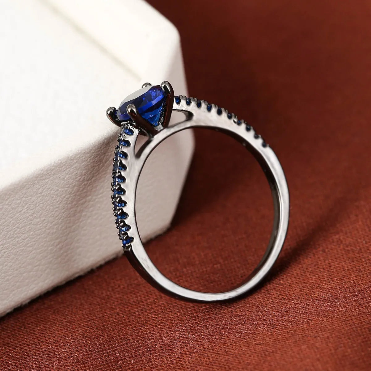Geometric hexagon copper ring with colourful zircon stones in a metallic electroplated finish.