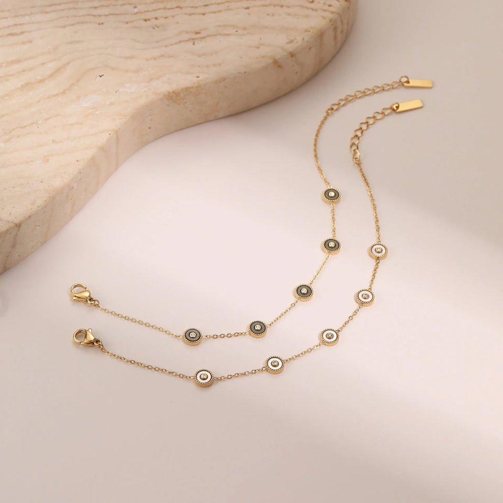Geometric fritillary design stainless steel bracelet with 18K gold plating and matching necklace